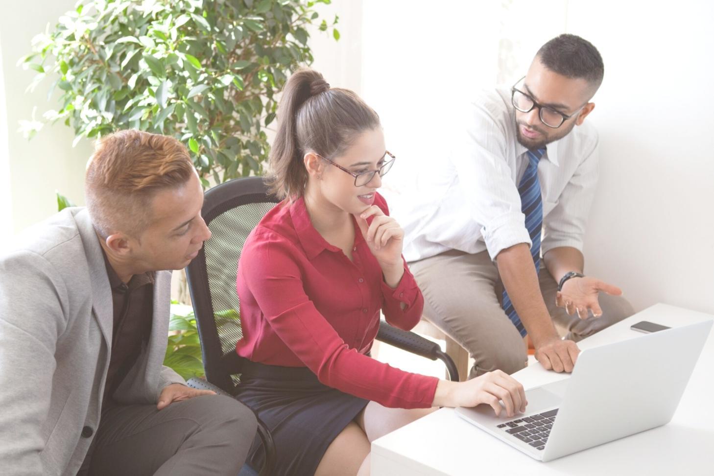 Financial modeling workshop session with participants working on laptops